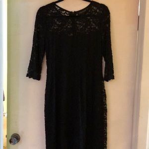 Fitted black lace dress, 3/4 sleeves, below knee.